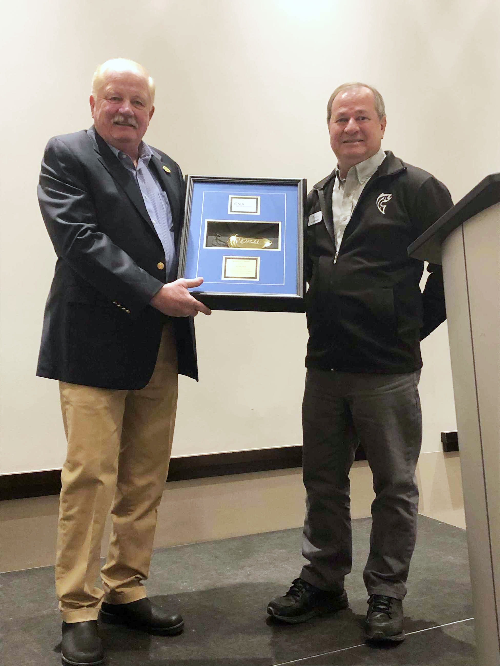 Phil Morlock receives President's Award from CSIA President Kim Rhodes.