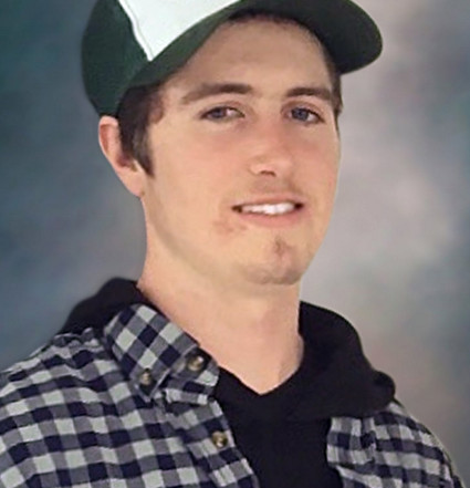 A Portrait of James Scissons. He is wearing a blue and white Cabela's ballcap.