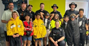 a group of children pose for the camera with police officers