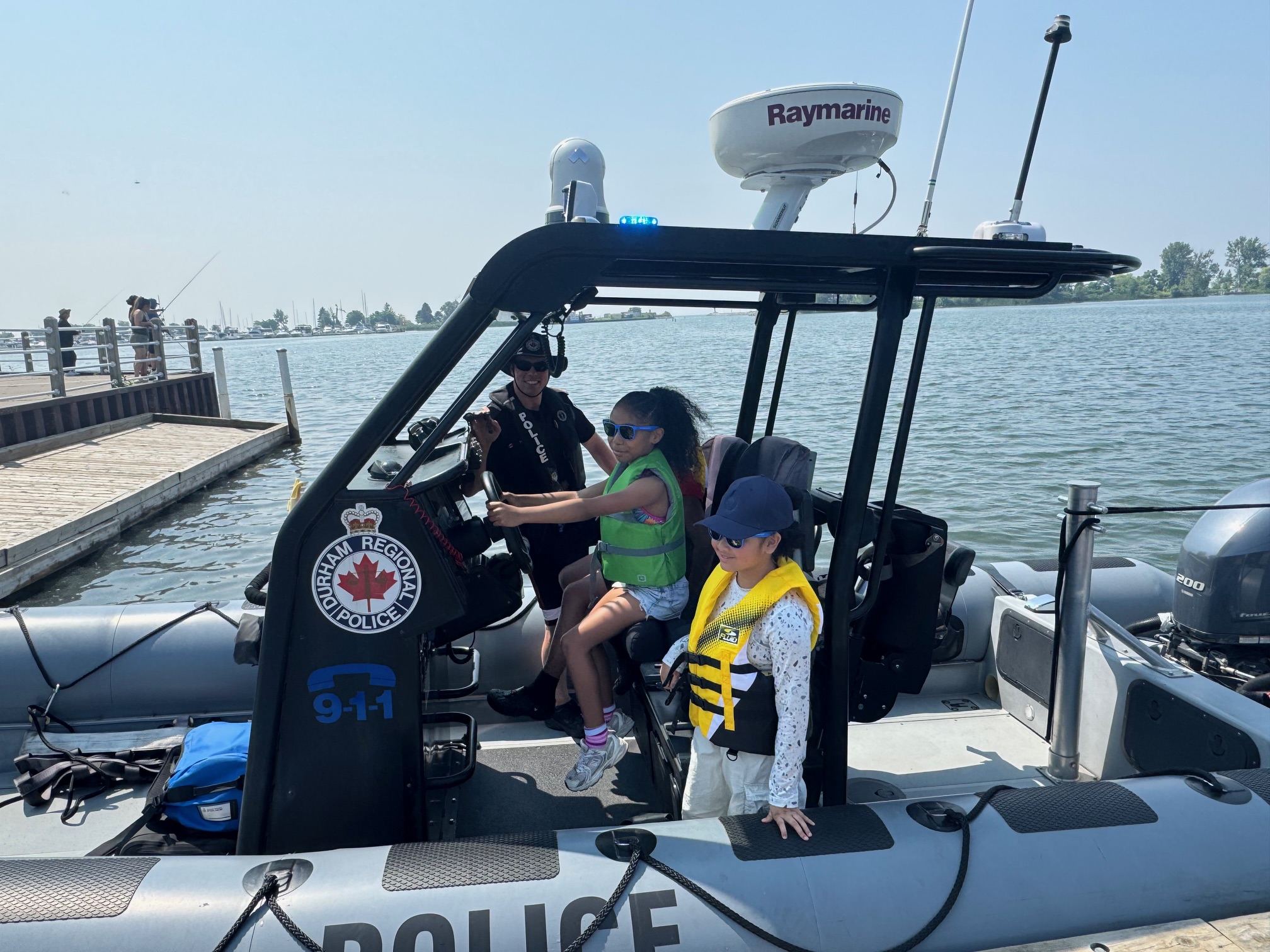 children sit in a police boat
